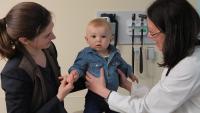 Doctor, baby and mother in exam room